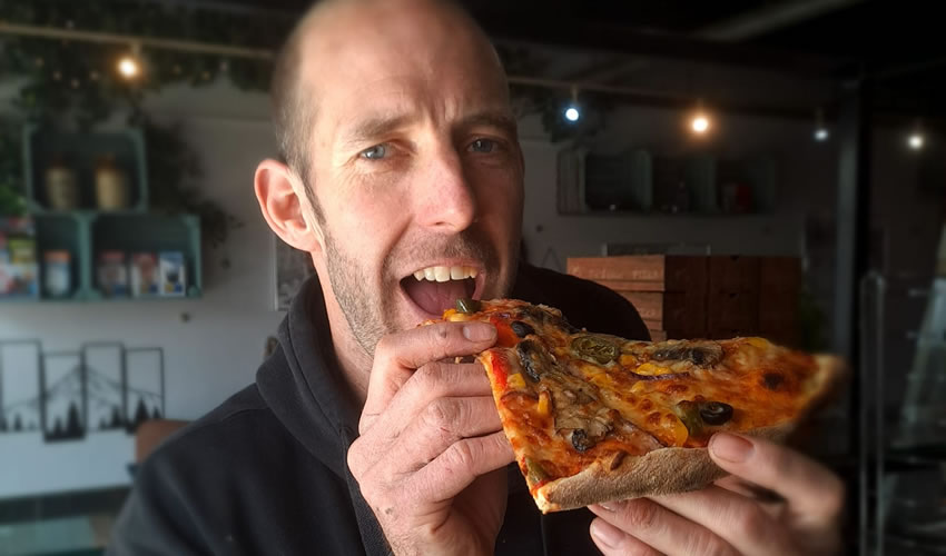 Pizza deals at Larry's - Jamie eating a slice of pizza