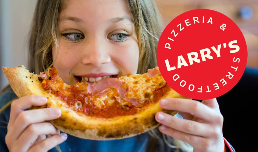 child eating pizza